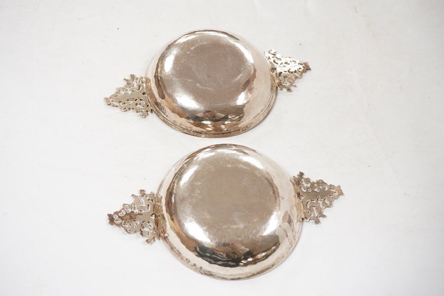 A pair of George V continental silver quaichs, with pierced lug handles and each engraved with a three-masted ship at sea, import marks for Berthold Hermann Muller, London, 1913, 17.3cm.